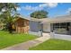 Ranch style home with stone and wood accents at 1921 Blue Heron Way, Palm Harbor, FL 34683