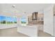Modern kitchen island with white cabinets and stainless steel appliances at 32252 Wetland Bird Vw, San Antonio, FL 33576