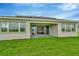 Home exterior showcasing a covered patio and grassy backyard at 32252 Wetland Bird Vw, San Antonio, FL 33576