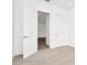 Spacious bedroom with an open door to another room and plush carpeting at 32252 Wetland Bird Vw, San Antonio, FL 33576