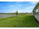Landscaped backyard with pond view and grassy area at 32252 Wetland Bird Vw, San Antonio, FL 33576