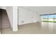 Open living space with tile floors, stairs, and sliding glass doors at 32252 Wetland Bird Vw, San Antonio, FL 33576