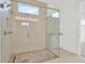 Spa-like shower with frameless glass enclosure and pebble stone floor at 32252 Wetland Bird Vw, San Antonio, FL 33576