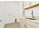 Clean laundry room with a sink and built-in cabinets at 32252 Wetland Bird Vw, San Antonio, FL 33576