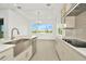 Bright kitchen boasts a large window overlooking a pond and modern finishes at 32252 Wetland Bird Vw, San Antonio, FL 33576