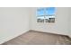 Bright bedroom with neutral carpet and a window offering a view of the neighborhood at 32252 Wetland Bird Vw, San Antonio, FL 33576