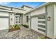 Modern home exterior with gray and white accents, paver driveway, and two-car garage at 32252 Wetland Bird Vw, San Antonio, FL 33576