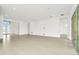 Spacious living room with tile floors and access to a covered patio at 32252 Wetland Bird Vw, San Antonio, FL 33576
