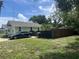 Light green house with a driveway and a wooden fence at 1161 Kingsley St, Clearwater, FL 33756