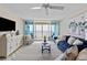 Bright living room with ocean view, featuring comfy seating and coastal decor at 7100 Sunset Way # 906, St Pete Beach, FL 33706