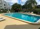 Community pool and surrounding patio area at 4681 1St Ne St # 309, St Petersburg, FL 33703