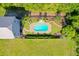 Aerial view of home, backyard, pool, and lush landscaping at 6419 Marbella Blvd, Apollo Beach, FL 33572