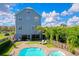 Stunning backyard featuring a pool and hot tub, perfect for outdoor entertaining at 6419 Marbella Blvd, Apollo Beach, FL 33572