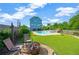 Relaxing backyard with lush lawn, pool, fire pit, and play area offers great outdoor enjoyment at 6419 Marbella Blvd, Apollo Beach, FL 33572
