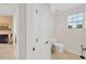 Hall bathroom featuring white fixtures and a decorative window at 6419 Marbella Blvd, Apollo Beach, FL 33572