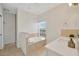 Serene bathroom featuring a soaking tub, walk-in shower, and well-lit vanity area at 6419 Marbella Blvd, Apollo Beach, FL 33572
