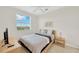 Bright bedroom with wicker frame bed, ceiling fan and a window with a pleasant neighborhood view at 6419 Marbella Blvd, Apollo Beach, FL 33572