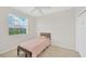 Bright bedroom with a cozy bed, tile floors, and natural light at 6419 Marbella Blvd, Apollo Beach, FL 33572