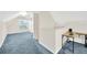 Upstairs bonus room with blue carpet and a desk area at 6419 Marbella Blvd, Apollo Beach, FL 33572