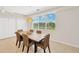 Bright dining room with woven dining set and large windows offering pleasant natural light at 6419 Marbella Blvd, Apollo Beach, FL 33572