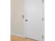 A white six-panel door with a silver knob, seamlessly blending with the neutral walls at 6419 Marbella Blvd, Apollo Beach, FL 33572