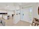 Bright foyer with white door and tile flooring, seamlessly connecting to the kitchen and dining areas at 6419 Marbella Blvd, Apollo Beach, FL 33572