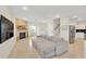 Bright living room featuring a fireplace, neutral decor, and tile floors at 6419 Marbella Blvd, Apollo Beach, FL 33572