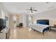Spacious main bedroom with tiled flooring, a ceiling fan and two windows at 6419 Marbella Blvd, Apollo Beach, FL 33572