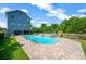 Outdoor pool and patio area with landscaped yard, hot tub, and play structure at 6419 Marbella Blvd, Apollo Beach, FL 33572