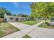 House exterior view showcasing a well-maintained lawn and driveway at 6430 Willow Wood Ln, Tampa, FL 33634