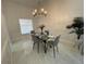 Bright dining area with glass-top table and gray chairs at 1460 Overland Dr, Spring Hill, FL 34608