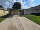 Home features a large backyard with a covered patio at 3208 E Powhatan Ave, Tampa, FL 33610