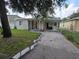 House exterior with a carport and red front door at 3208 E Powhatan Ave, Tampa, FL 33610