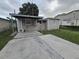 Home features a large backyard with a covered patio at 3208 E Powhatan Ave, Tampa, FL 33610