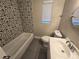 Updated bathroom with patterned tile and a new vanity at 3208 E Powhatan Ave, Tampa, FL 33610
