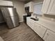 Modern kitchen features stainless steel appliances and white cabinetry at 3208 E Powhatan Ave, Tampa, FL 33610