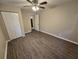 Spacious bedroom featuring wood-look floors and a ceiling fan at 3208 E Powhatan Ave, Tampa, FL 33610