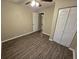 Bright bedroom with wood-look flooring and ample closet space at 3208 E Powhatan Ave, Tampa, FL 33610