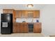 Bar with cabinets, sink, beverage cooler and black refrigerator at 500 Treasure Island Cswy # 406, Treasure Island, FL 33706