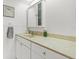 Bright bathroom with a vanity cabinet, solid surface countertop, and a mirrored wall cabinet at 500 Treasure Island Cswy # 406, Treasure Island, FL 33706