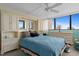 Bedroom with bed and dresser and large windows at 500 Treasure Island Cswy # 406, Treasure Island, FL 33706