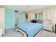 Bedroom with built-in cabinets and blue bedding at 500 Treasure Island Cswy # 406, Treasure Island, FL 33706