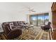 Relaxing living room featuring a large sectional sofa and access to a balcony at 500 Treasure Island Cswy # 406, Treasure Island, FL 33706