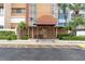 Condo building entrance with awning and landscaping at 500 Treasure Island Cswy # 406, Treasure Island, FL 33706