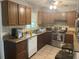 Cozy kitchen with wood cabinets, stainless steel appliances, and a breakfast bar at 120 S San Remo Ave, Clearwater, FL 33755