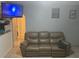 Cozy living room with a leather couch and large-screen TV at 120 S San Remo Ave, Clearwater, FL 33755