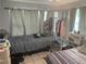 Bedroom with two twin beds and a clothing rack at 120 S San Remo Ave, Clearwater, FL 33755