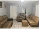 Simple living room with brown leather couches and a recliner at 120 S San Remo Ave, Clearwater, FL 33755