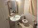 Main bathroom with pedestal sink, toilet, and bathtub at 120 S San Remo Ave, Clearwater, FL 33755