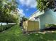 Side view of house with wooden fence and landscaping at 11335 Grandville Dr, Temple Terrace, FL 33617